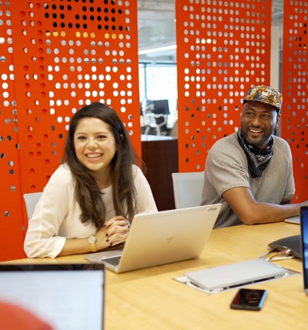 Two employees chatting at a table in the office 