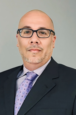 Sergio, a man wearing glasses and a suit