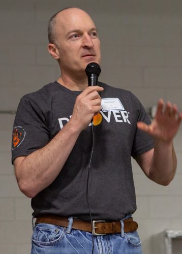 Dan holding a microphone