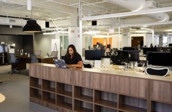 Discover employee sitting a table in open office space