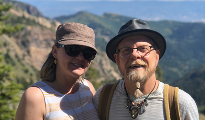 Image of Angie and another person posing with mountains